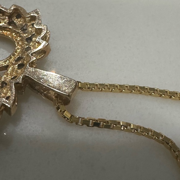 This is a yellow gold open heart diamond pendant necklace on a gold chain - Picture 6 of 8